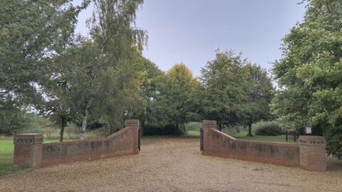 Muchwood Burial Site Entrance 2024, beautiful green trees surrounding the brick entrance