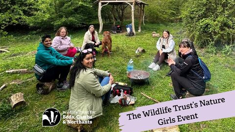 group of women sitting around fire bowl